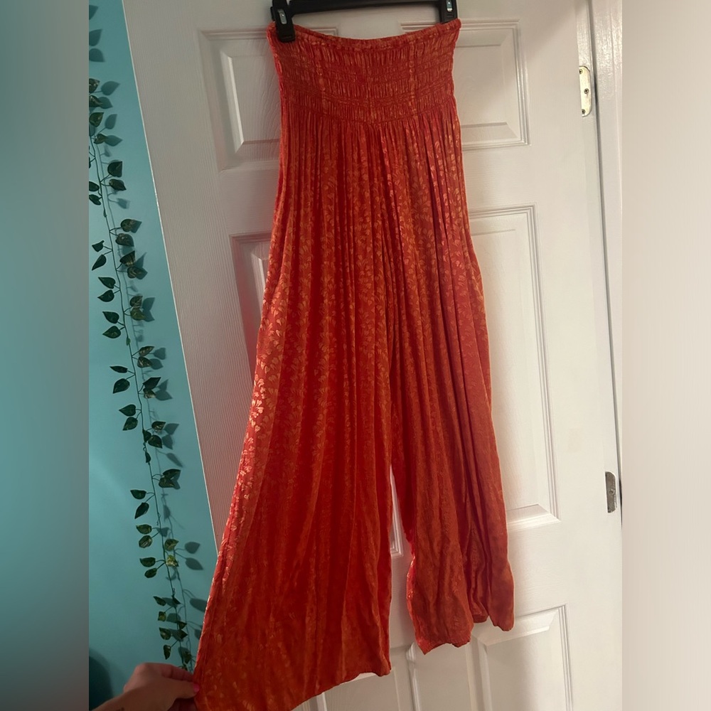 Out from under orange flowy pants